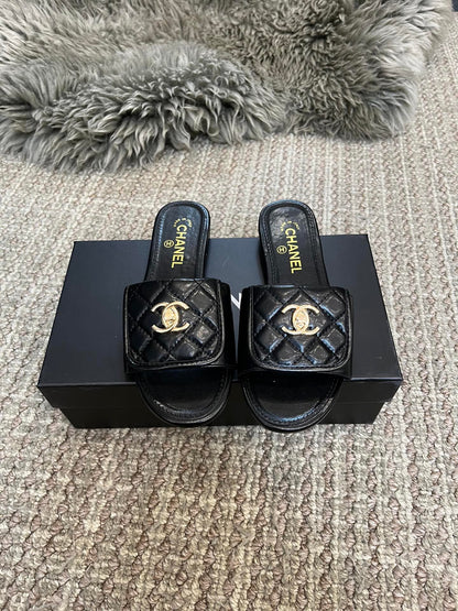 Luxury diamond-quilted flat slides with metal embellishments